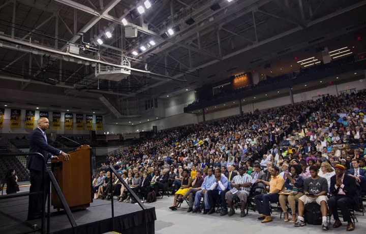 An author stands at a podium and delivers a lecture as part of the Common Book Program.